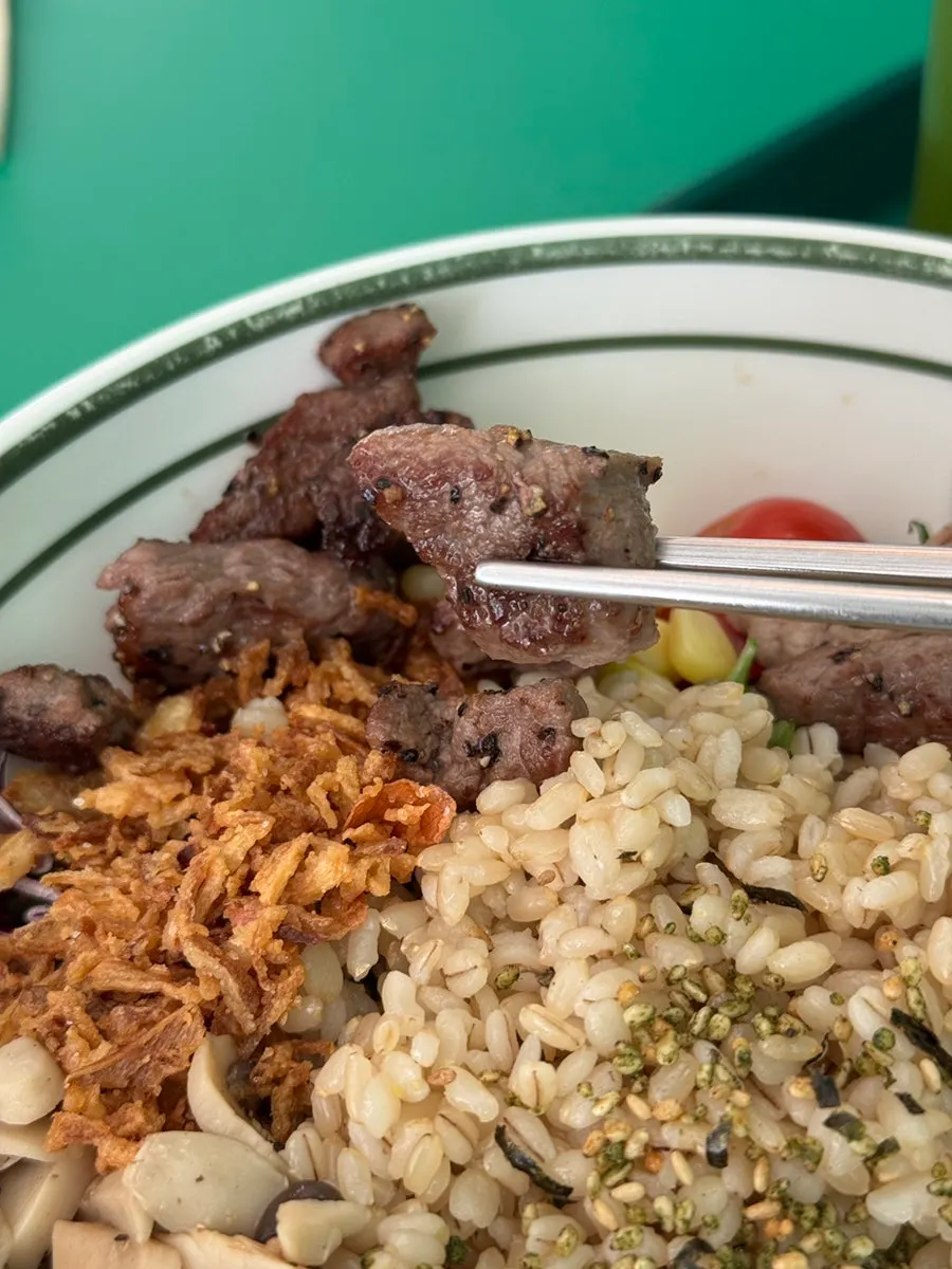 Close-up of poke bowl topped with three kinds of meat