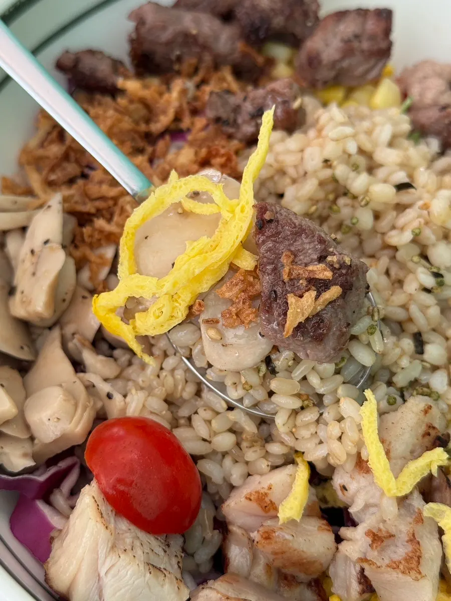 Thinly grilled beef brisket topping with brown rice and barley