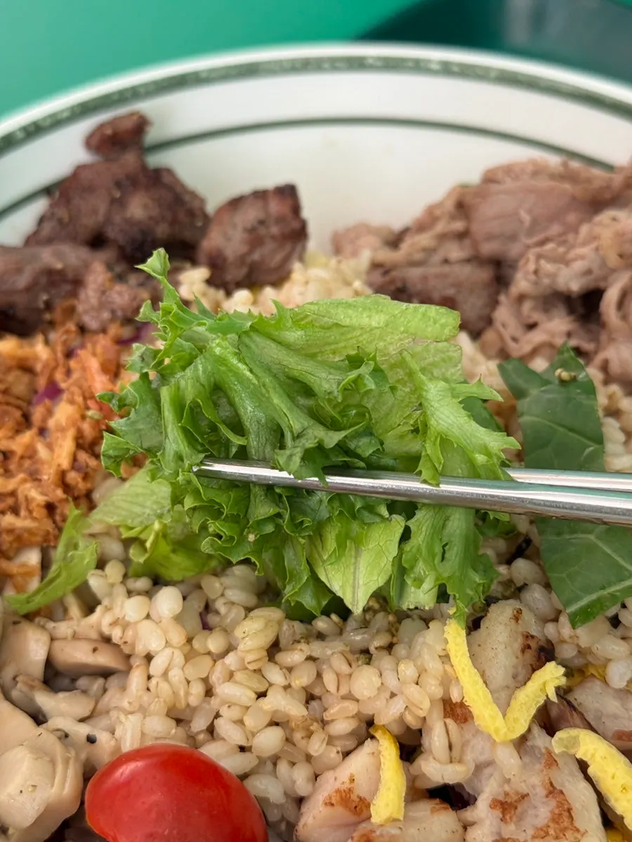 Mixing the Meat All-in-One bibim poke with vegetables