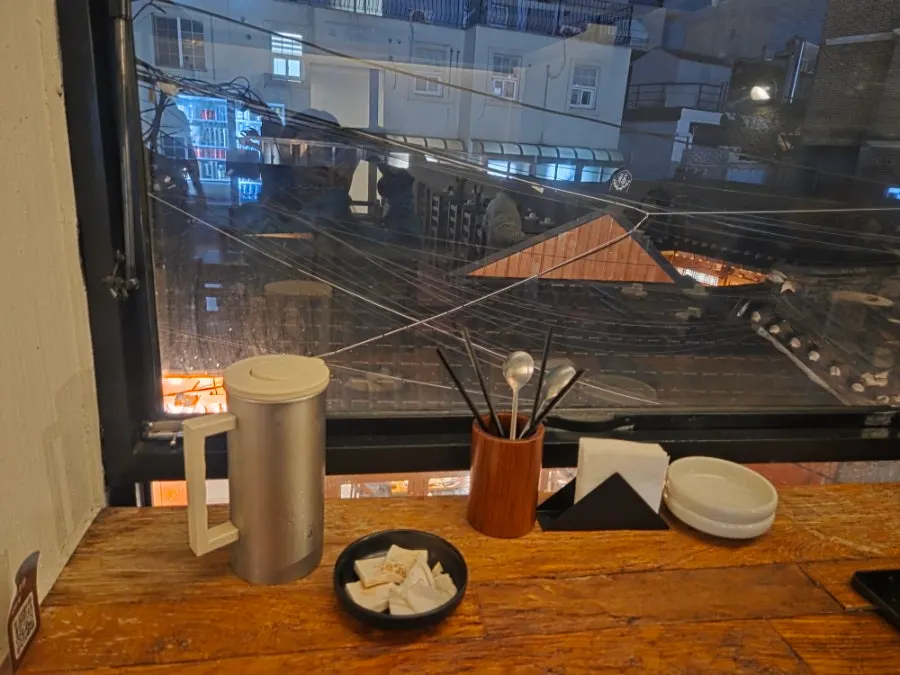 Hanok view visible from the window bar table