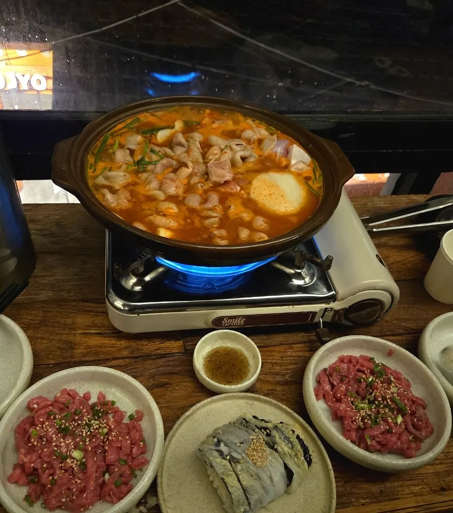 A single piece of egg kimbap topped with beef tartare