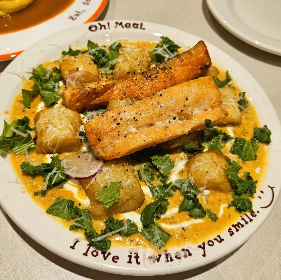 A plate of salmon steak gnocchi