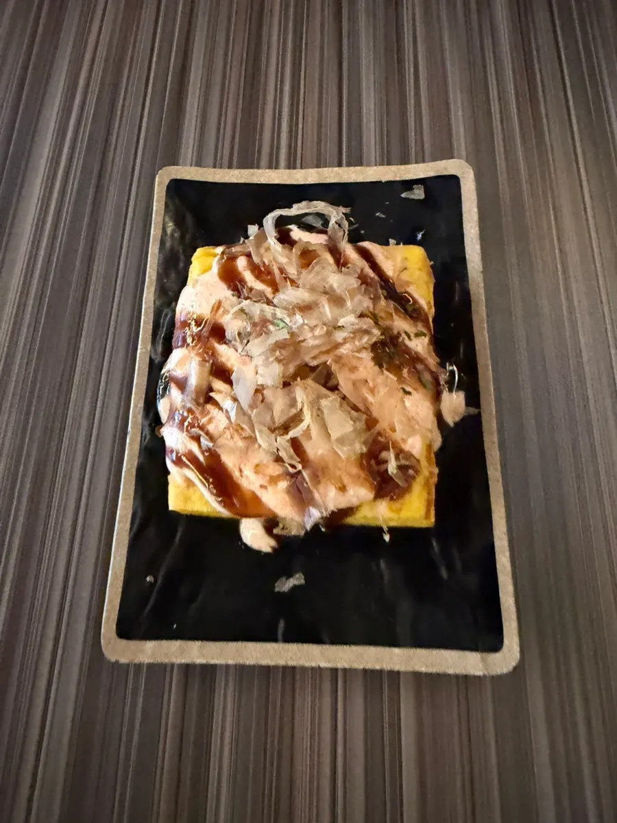 Pollock roe omelet topped with sauce and bonito flakes