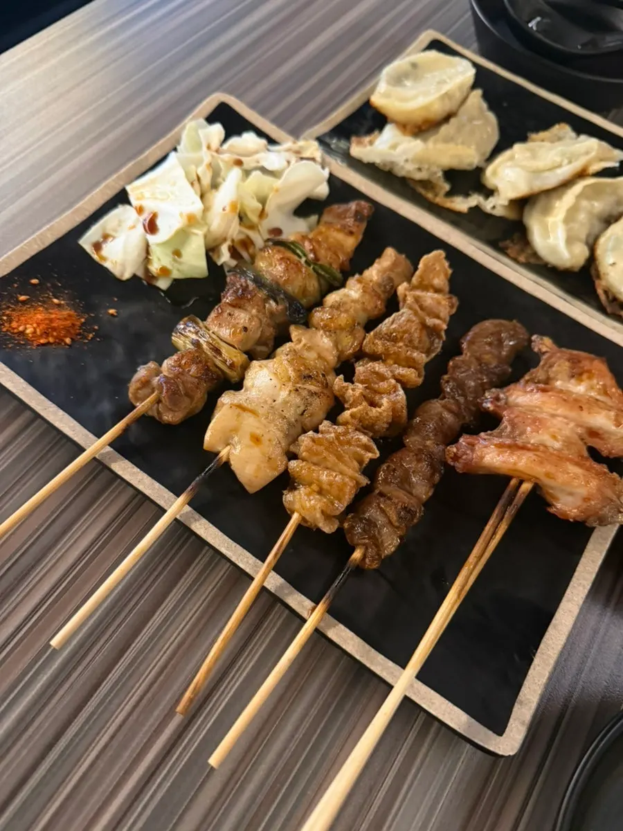 Table spread with sukiyaki and skewers