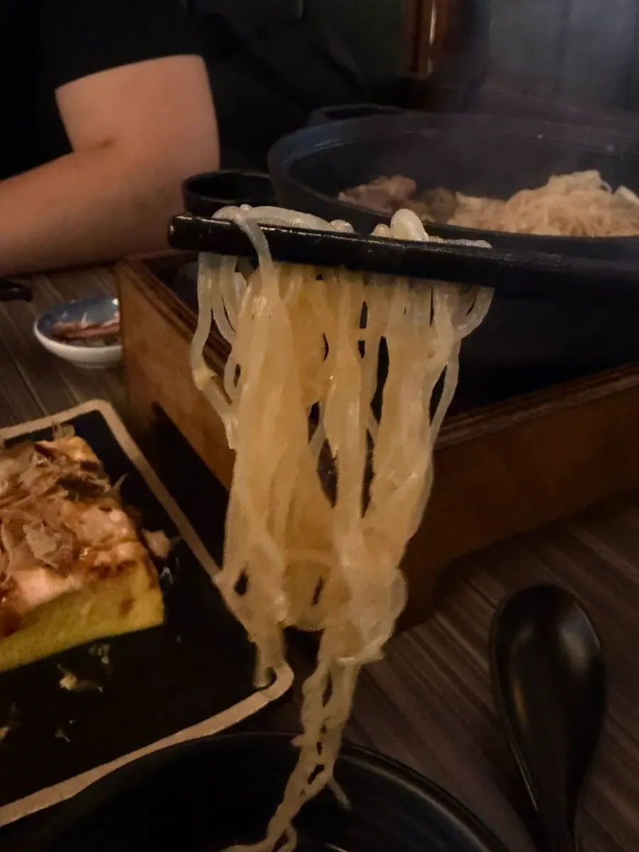Tofu and ingredients in sukiyaki broth