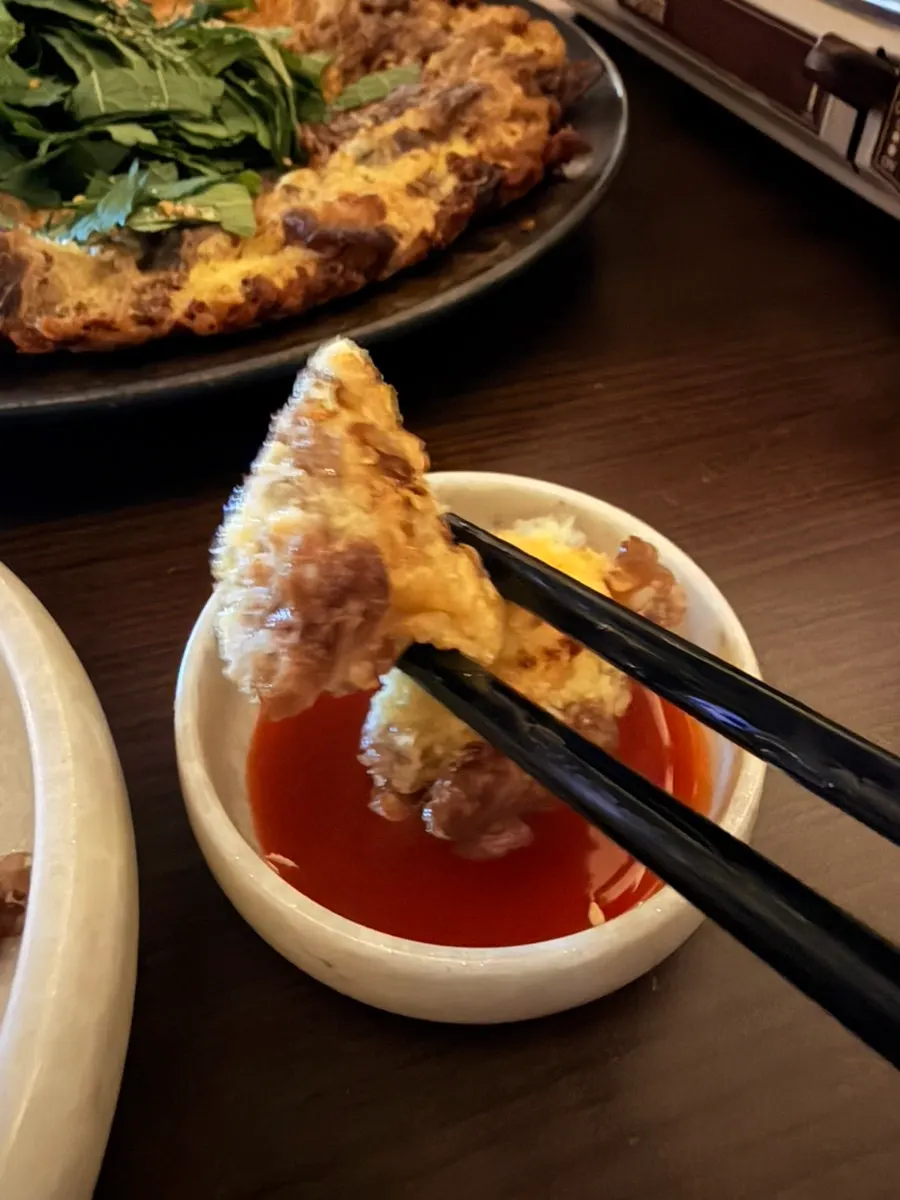 Thick pan-seared beef yuk-jeon with perilla-leaf scallion salad