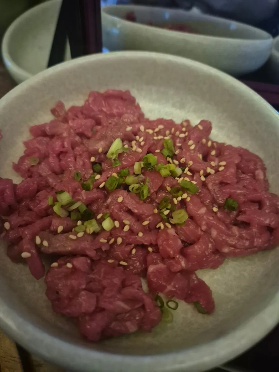 Ttubbeul Hanwoo Yukhoe (hanwoo beef tartare) plated on a mirror-like tray