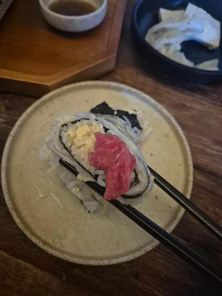 Aged kimchi egg sushi served with the beef tartare