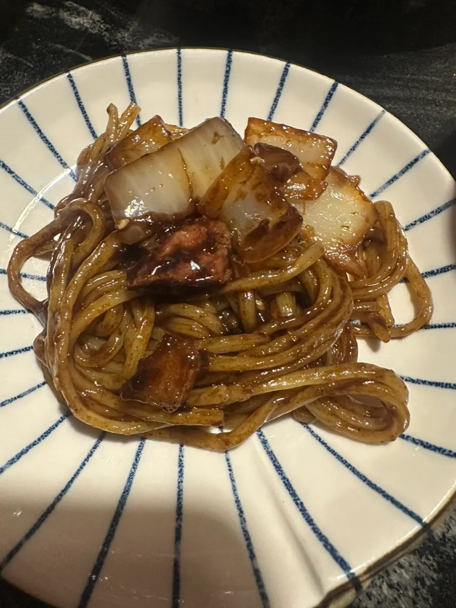 A chopstick-full of ganjjajang lifted up