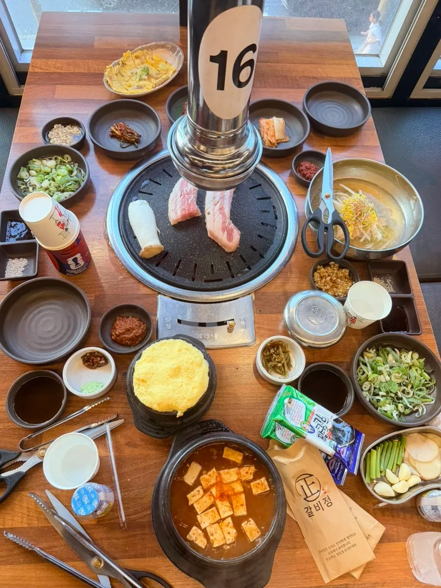 Galbijeong's fresh pork belly grilling on the grill