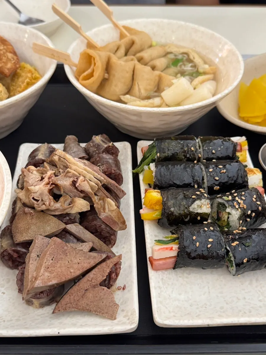 Full shot of the bunsik spread with tteokbokki, fried snacks, sundae and kkoma gimbap