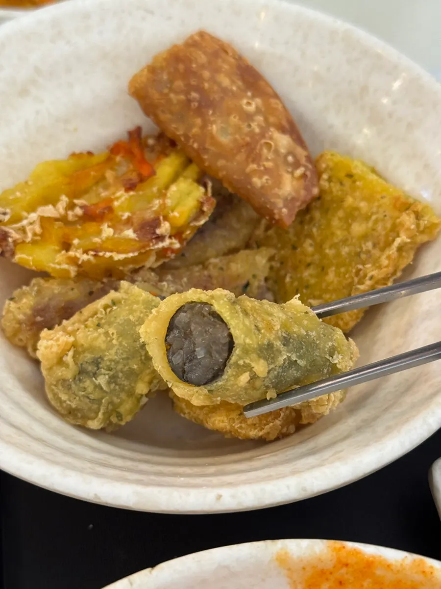 Kkoma gimbap laid out together with fried snacks