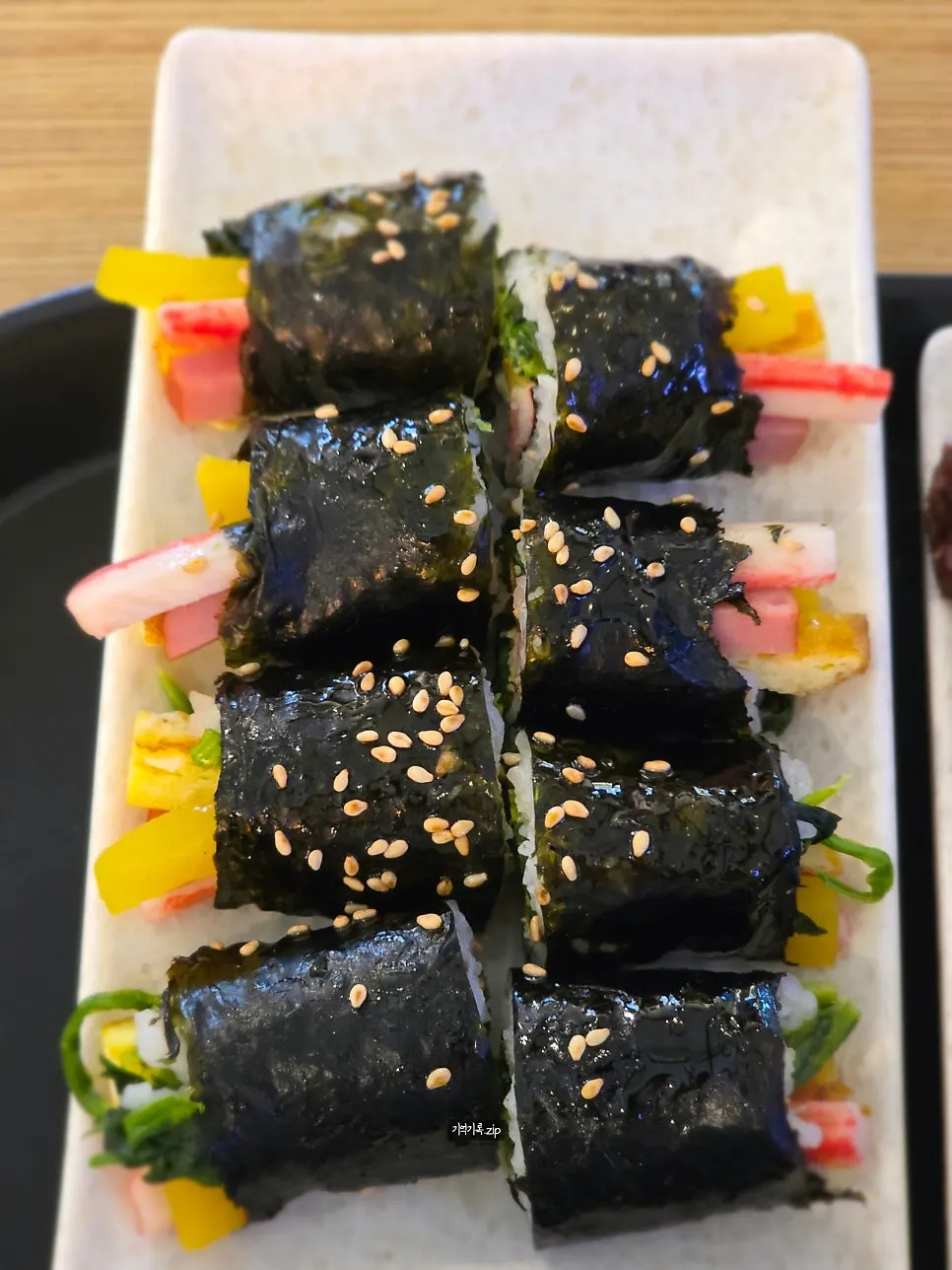 Eight halved pieces of mini gimbap