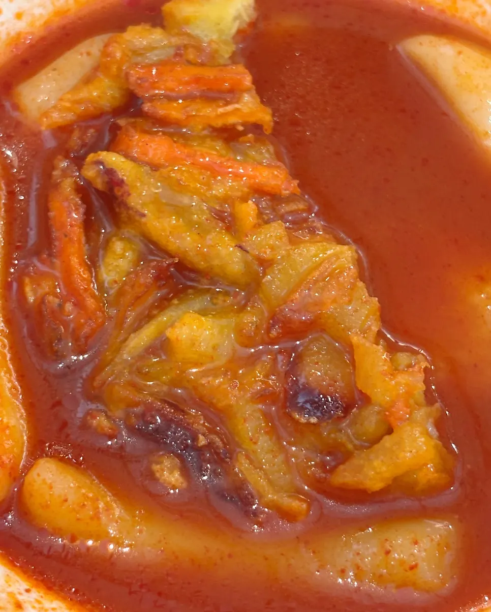 Dipping a fritter into the broth