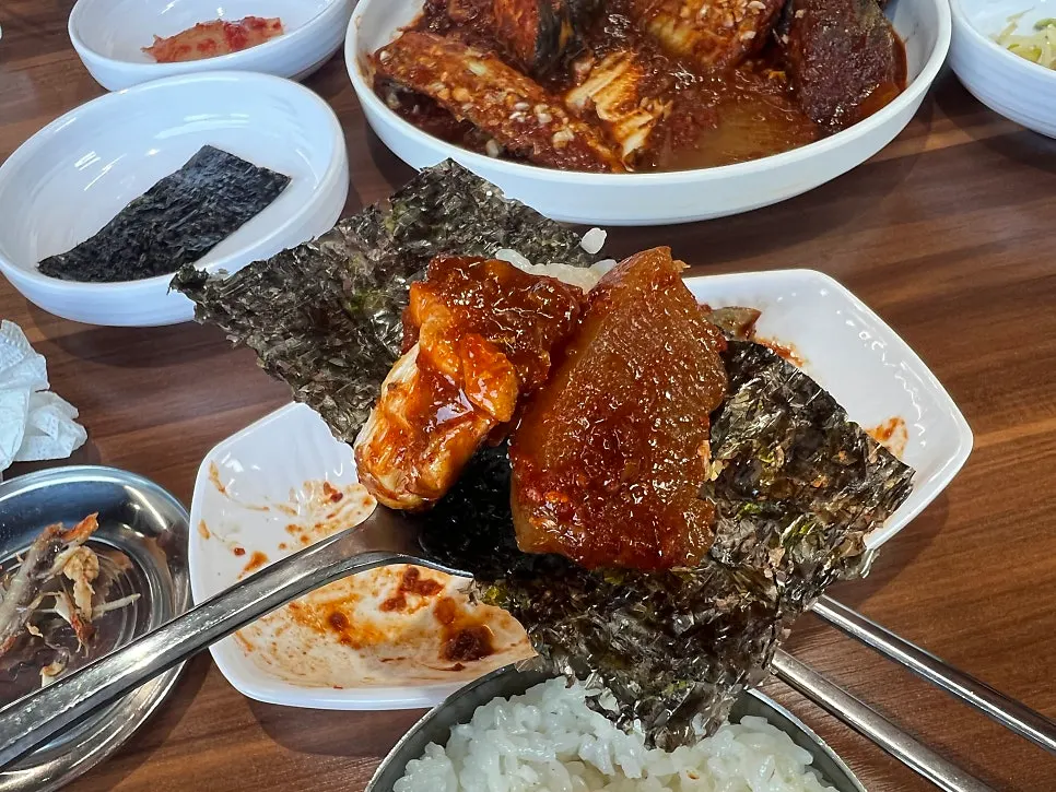 A meal spread with rice bowl alongside the stew