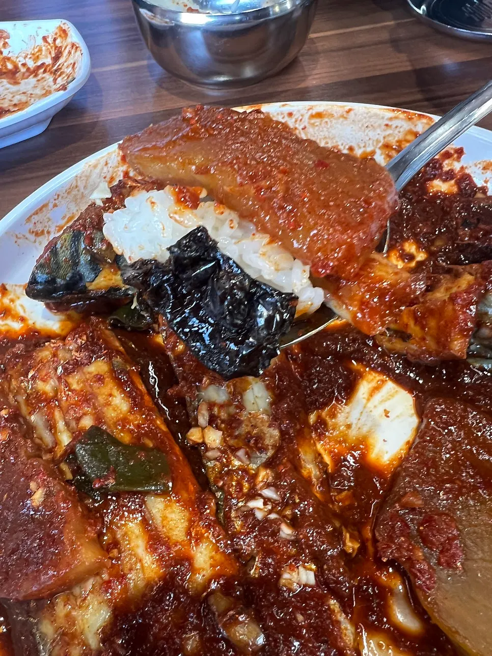 A bite of braised fish topped with bean sprouts