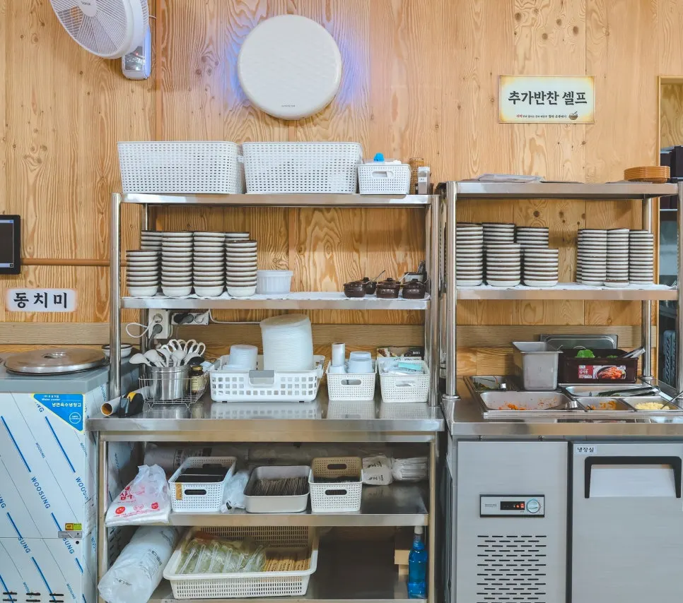 Kimchi and side dishes laid out at the self-serve bar