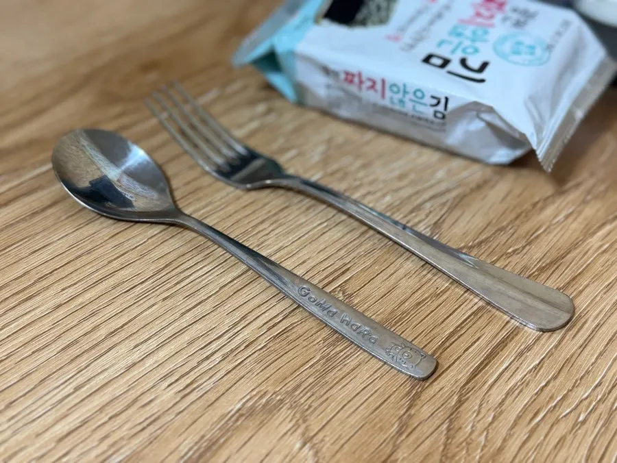 Kid-sized fork and spoon set on the table