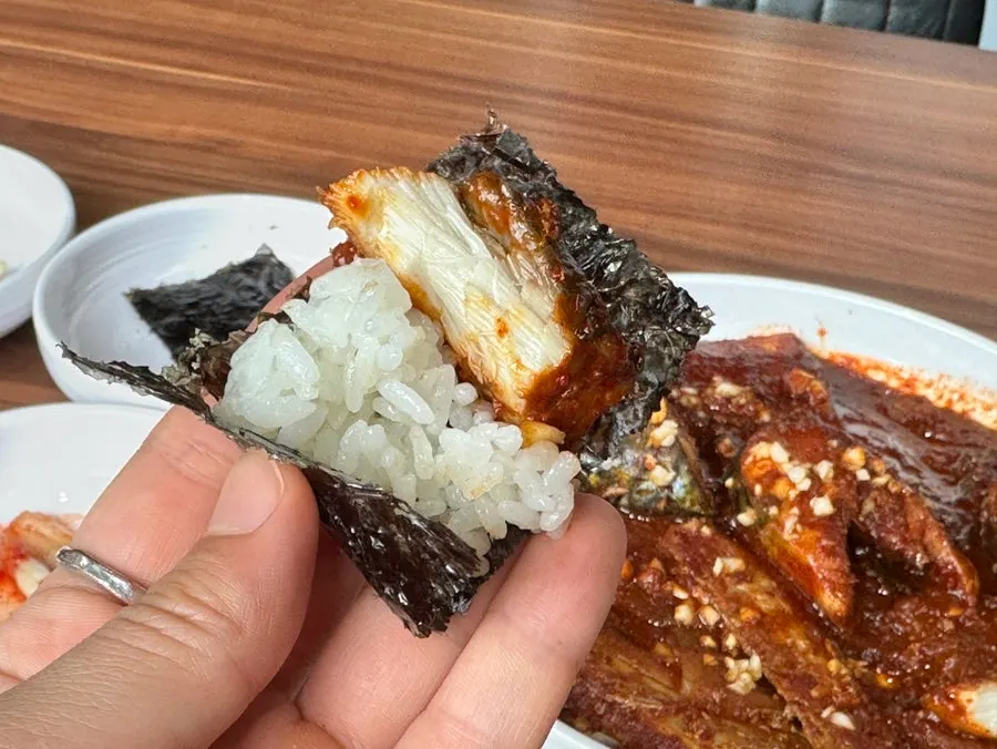 A spoonful of jorim radish placed on top of rice