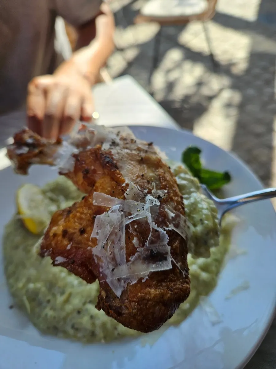 A whole chicken thigh served on top of the risotto