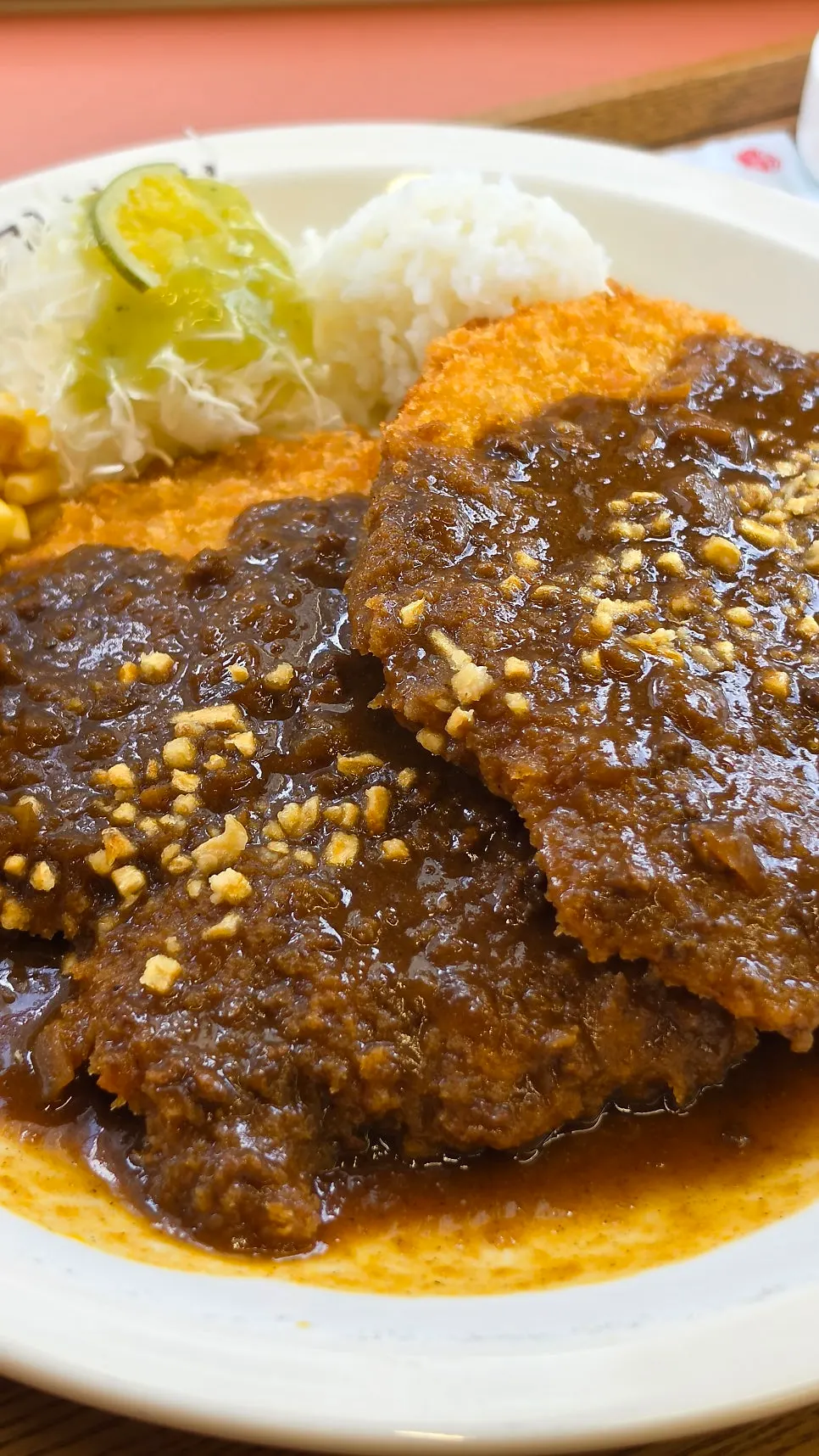 Two large pieces of pork cutlet served together