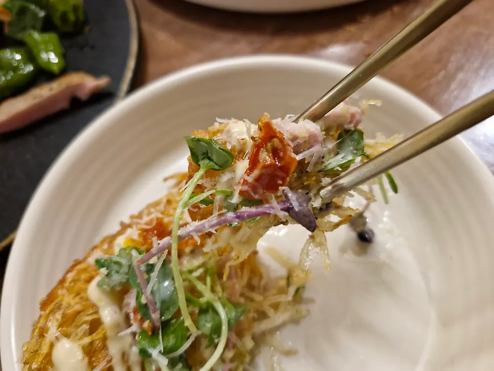 Close-up of tenderloin and cheese on the potato pancake