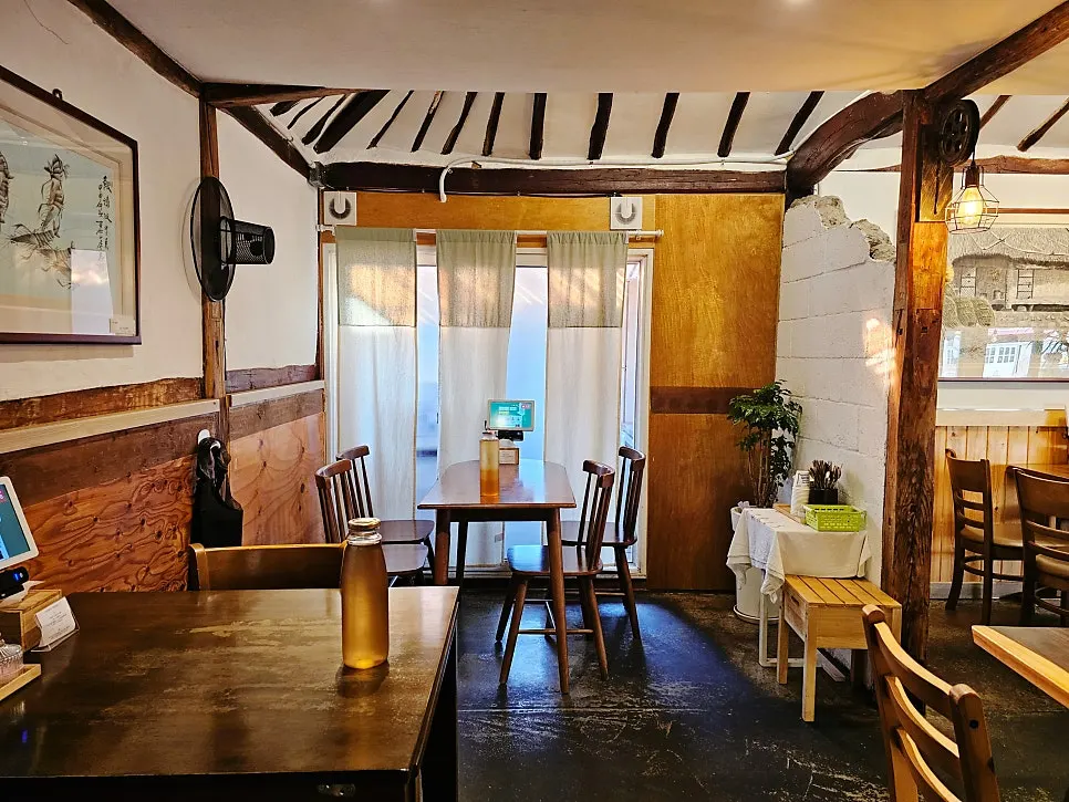 Interior of Hyeondae Memil with exposed rafters and beams