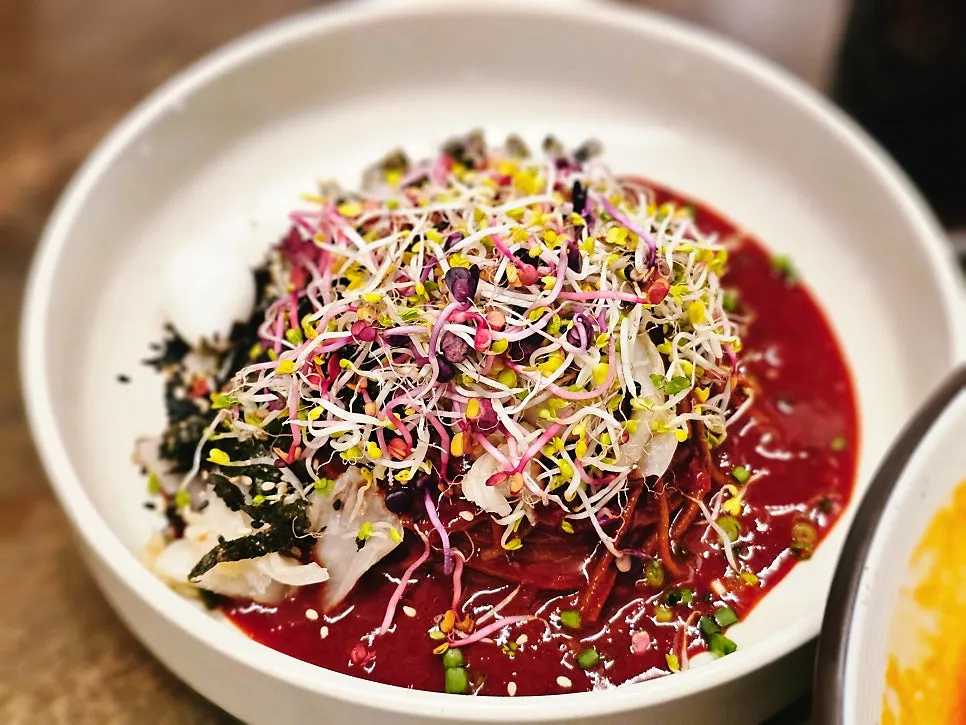 Bibim mak guksu topped with sprouts at Hyeondae Memil