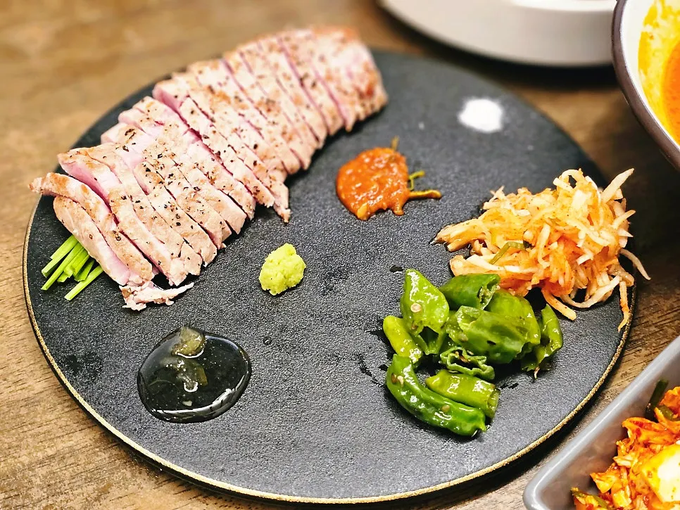 A plate of sous vide pork tenderloin at Hyeondae Memil