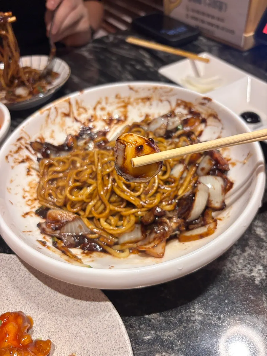 Close-up of springy noodles mixed with ganjjajang sauce
