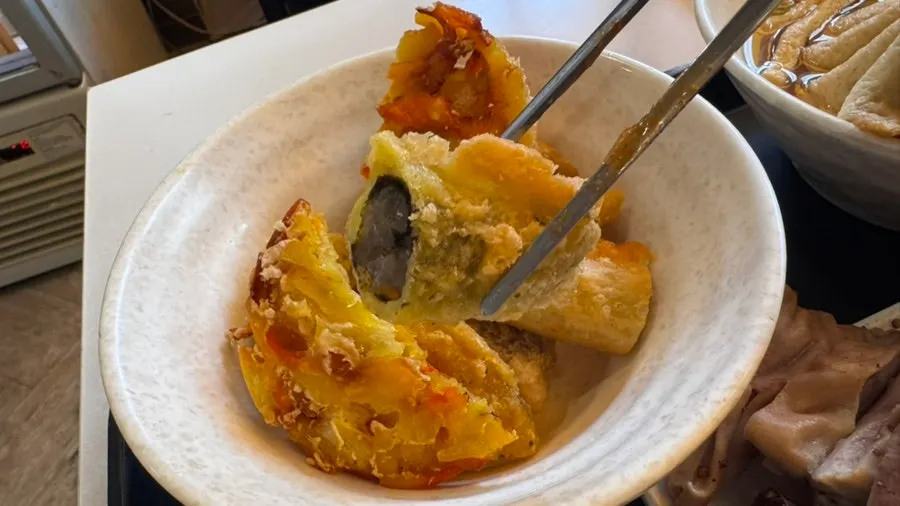 Fritter dipped in tteokbokki sauce