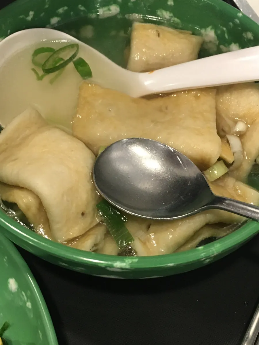 Mini gimbap dipped into broth