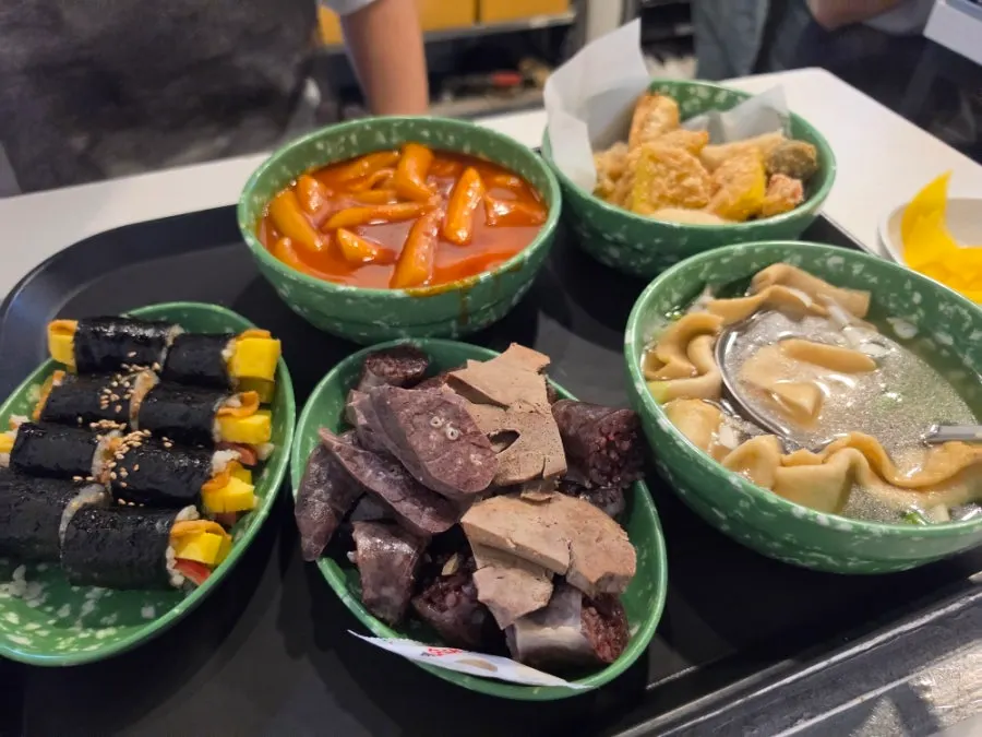 Full spread of tteokbokki, sundae, fried snacks, gimbap, and fish cake