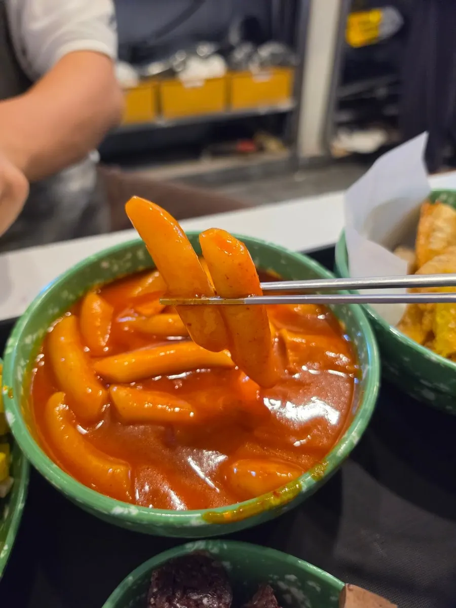 Fried snack dipped into the thick tteokbokki sauce