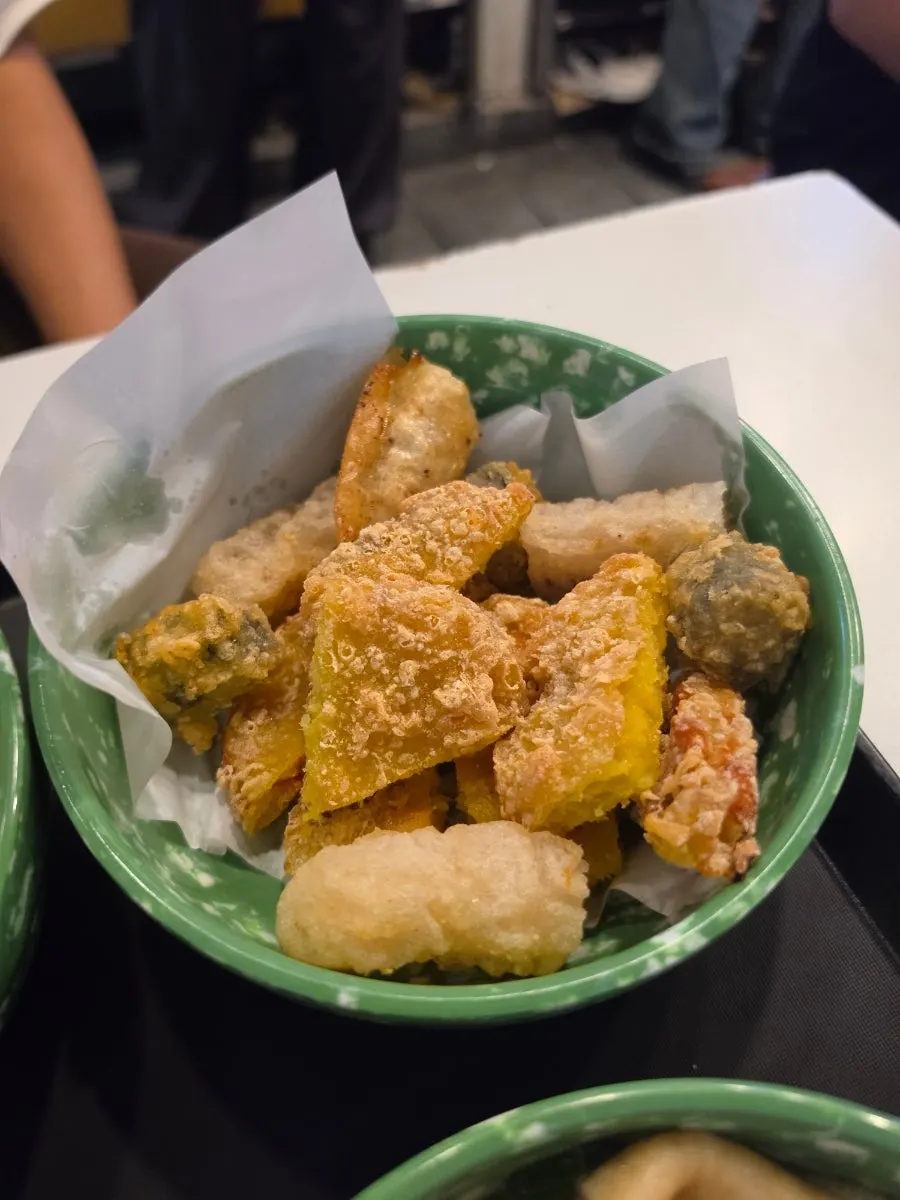 Assorted fried snacks including mandu, sweet potato, kimmari, and squid