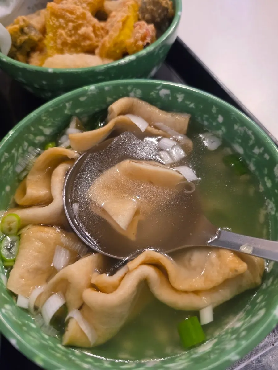 Two pieces of fish cake served with hot broth