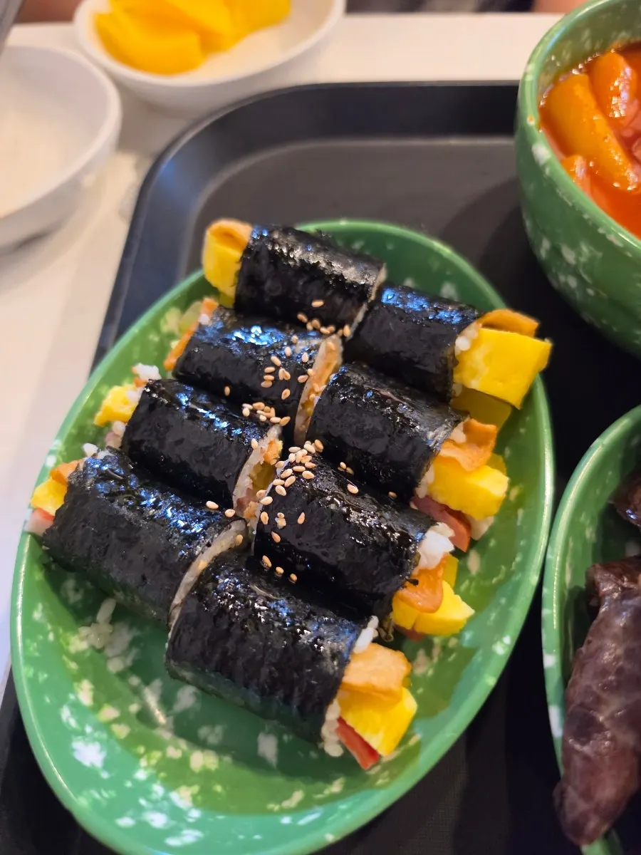 A plate of gimbap with a sesame oil aroma