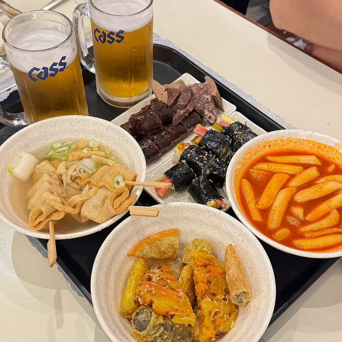 A full spread of the tteokbokki combo set at Hyeonseonine Yongsan Main Branch