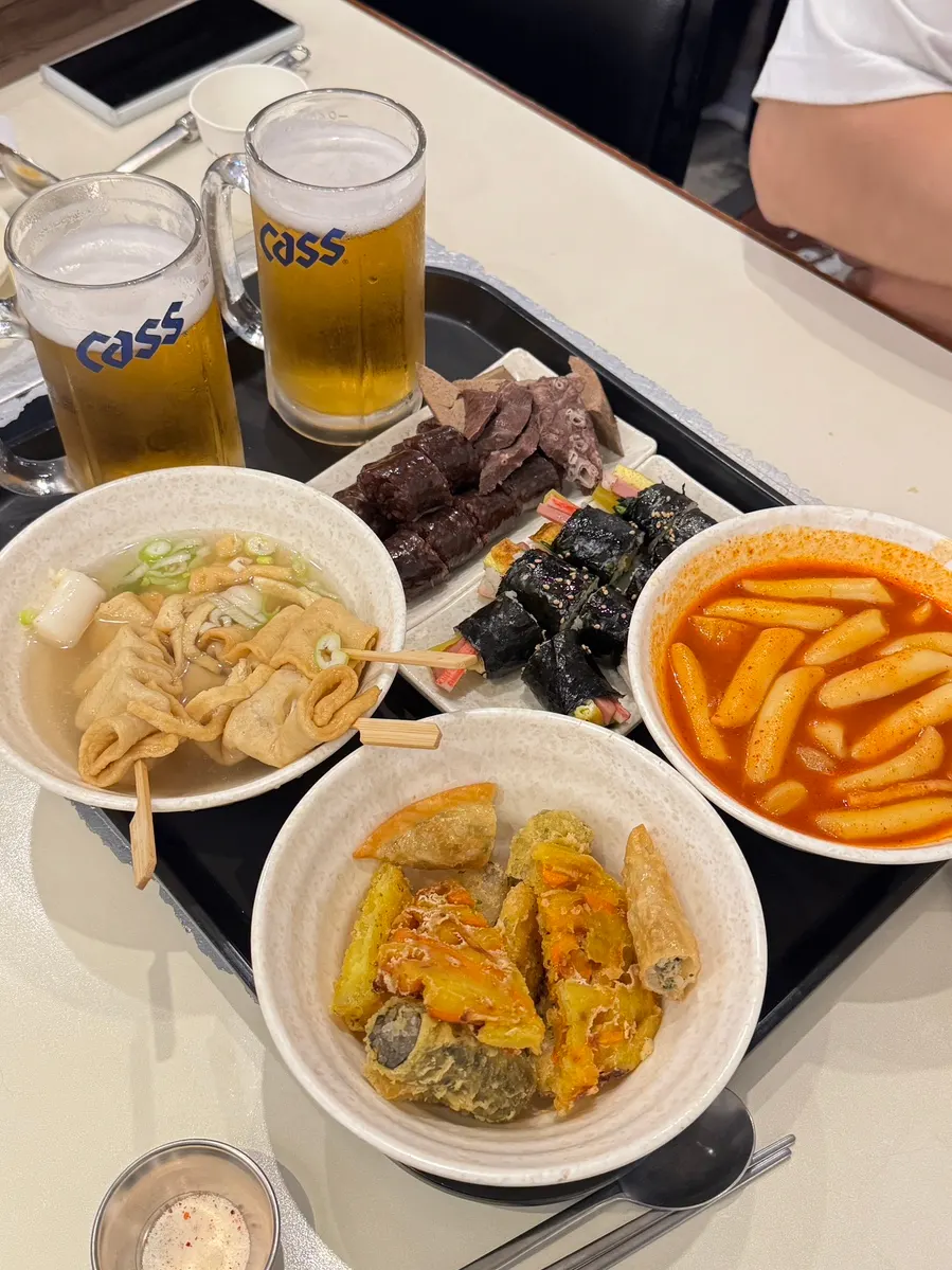 Table with bunsik dishes and draft beer together