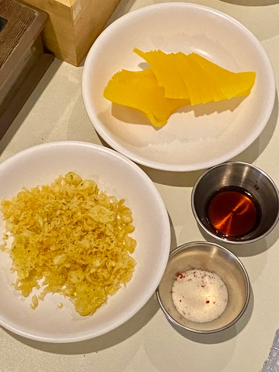 Self-serve bar with pickled radish and fried batter flakes