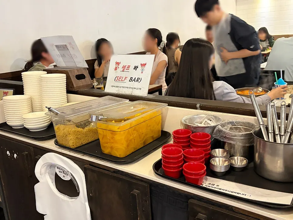 Self-serve bar with aprons, pickled radish, and small plates