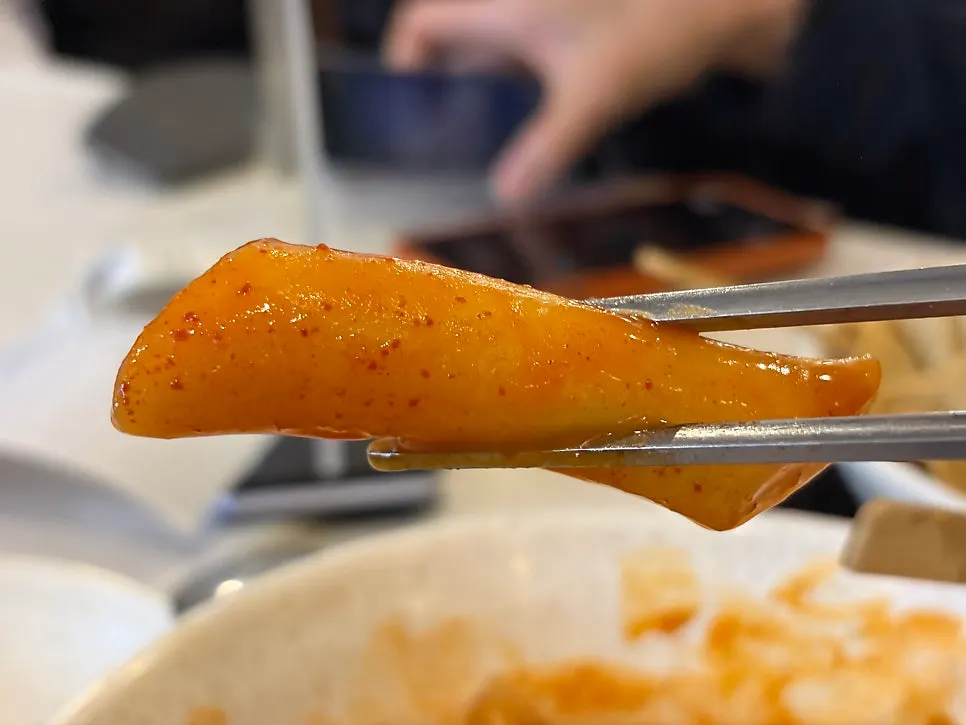 A bite of tteokbokki with sweet-spicy sauce