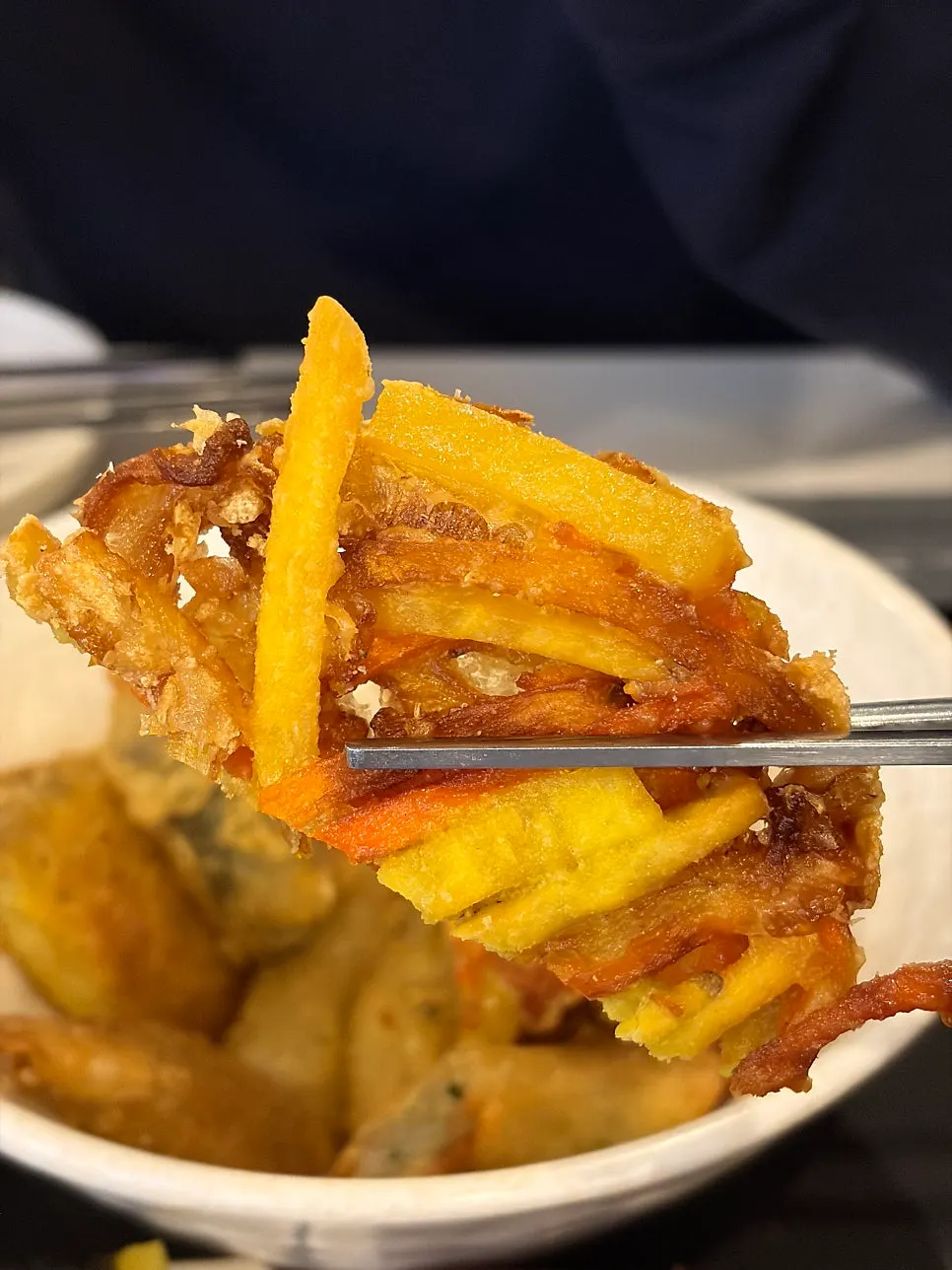 Crispy fritter dipped in tteokbokki sauce