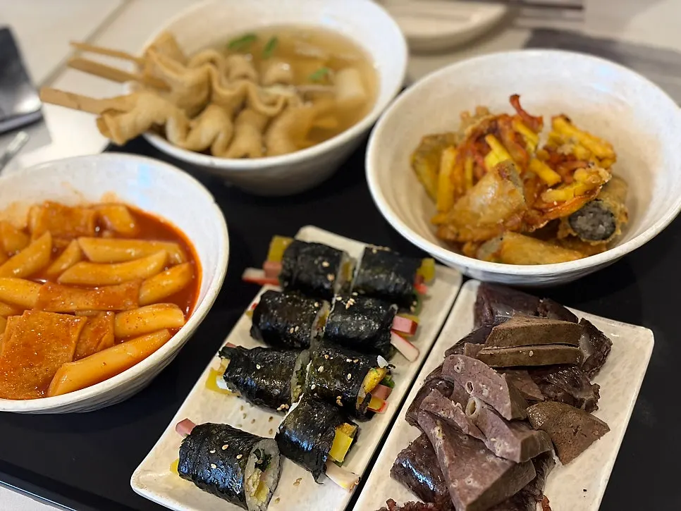 Combo set with tteokbokki, fritters, gimbap, sundae, and fish cake