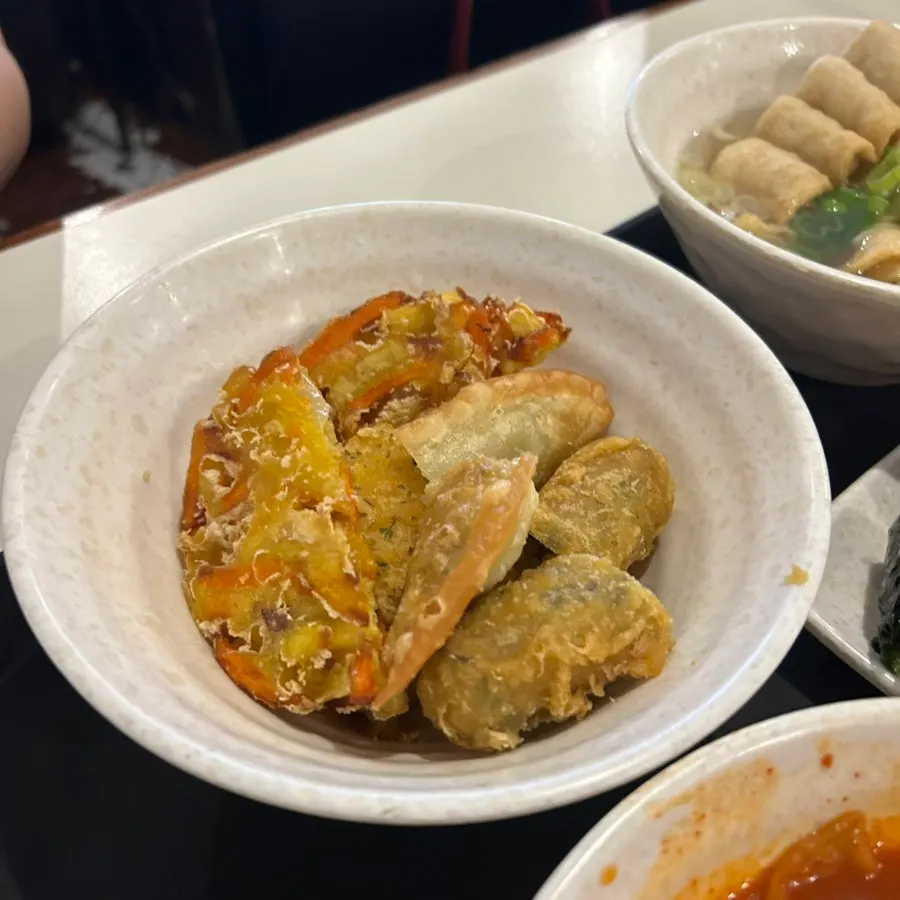 Fritter dipped into tteokbokki sauce
