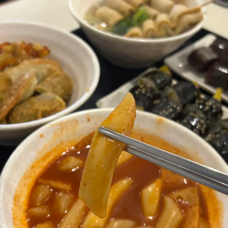 Finished plates of tteokbokki and fritters