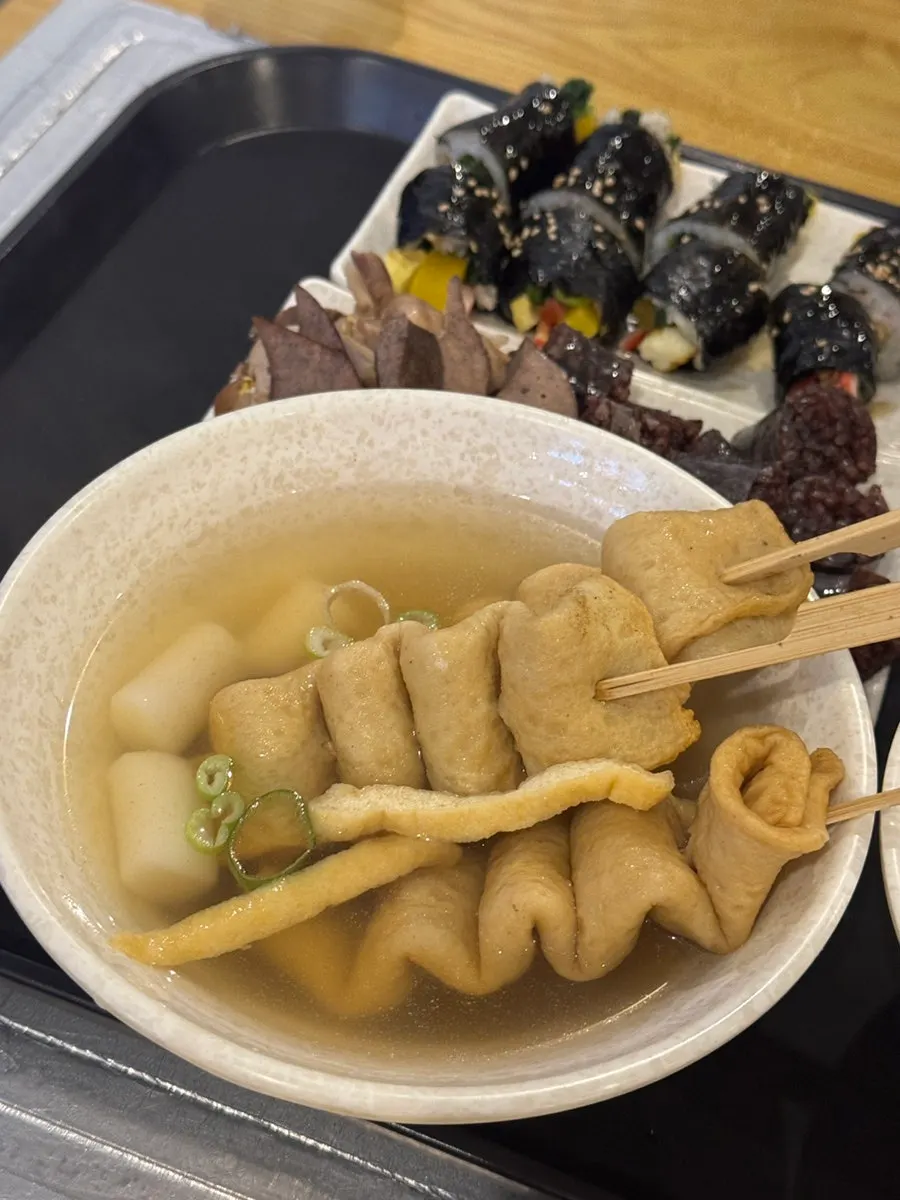 Three large fish cake skewers served with broth