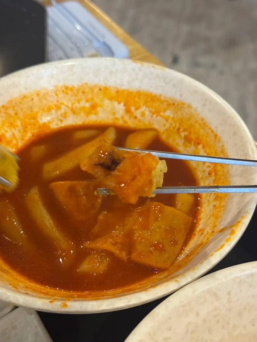 Crispy gimmari dipped in tteokbokki sauce