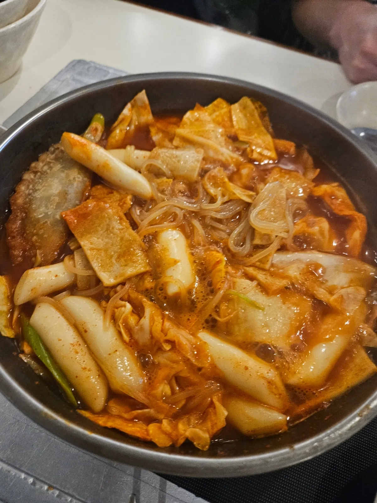 Instant tteokbokki for two topped with jjolmyeon, eggs, and dumplings