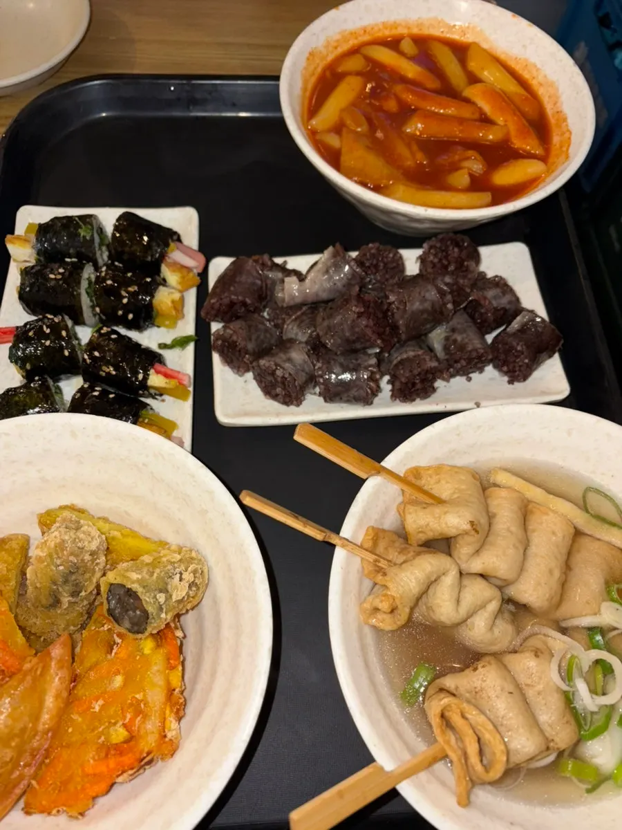 Table with tteokbokki, sundae, fritters, and gimbap together